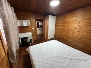 a bedroom with a white bed and a desk at carmel cabins suite 6 in Yājur +25 photos