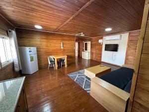 a room with a kitchen and a table and a refrigerator at carmel cabins suite 6 in Yājur