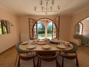a dining room with a large wooden table and chairs at Los Arcos in Annonay +55 photos