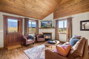 a living room with a couch and a fireplace at Glacier River Ranch - Flathead in Columbia Falls