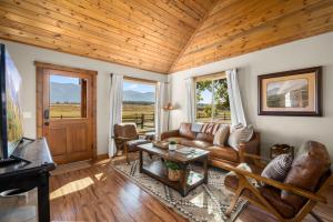 a living room with a couch and a table at Glacier River Ranch - Middle Fork in Columbia Falls