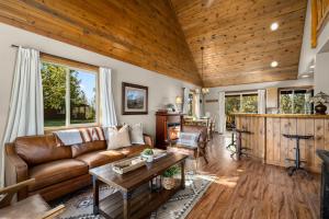 a living room with a couch and a table at Glacier River Ranch - Middle Fork in Columbia Falls