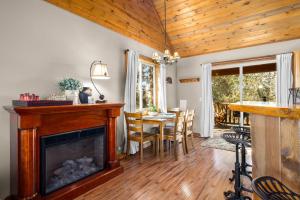 a living room with a fireplace and a table with chairs at Glacier River Ranch - Middle Fork in Columbia Falls