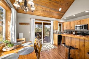 a kitchen and dining room with a table and chairs at Glacier River Ranch - Middle Fork in Columbia Falls +19 photos