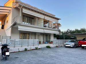 a motorcycle parked in a parking lot in front of a house at SUMU Luxury Apartment in Lefkada
