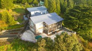 an aerial view of a large house in the forest at Deodar Manor - Guest House Khajjiar in Khajjiar 