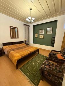 a bedroom with a large bed and a green wall at Deodar Manor - Guest House Khajjiar in Khajjiar 