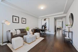 a living room with a couch and a table at The Oakville House in Oakville