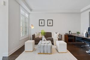 a living room with a couch and a table at The Oakville House in Oakville