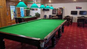 a pool table in a room with a green at 35 Strawberry Hill, Tolroy Manor in Hayle