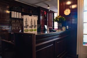 a bar with a wooden counter in a restaurant at Boutique Hotel De Doelen in Groningen +28 photos