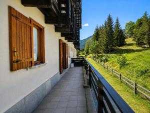a balcony of a building with a window at Hostdomus - Seguret in Cesana Torinese