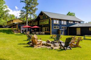 a group of chairs sitting in front of a lodge at Adirondack Spruce Lodge in Wilmington
