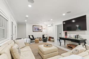 a living room with a couch and a piano at Battery Place in Savannah