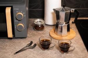 a coffee maker and two cups of coffee on a counter at Private Terrace, Residential Area, Beach & Surf, El Médano in El Médano