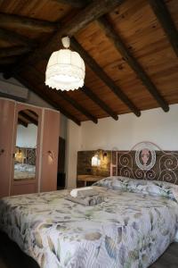a bedroom with a large bed and a chandelier at Casa da Moleira in Chaveirinha