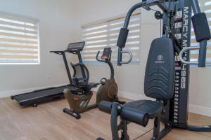 a gym with two exercise bikes in a room at Royale Jazz Hotel in Kingston
