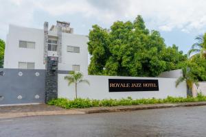 a white building with a sign that reads ropez kishi hotel at Royale Jazz Hotel in Kingston