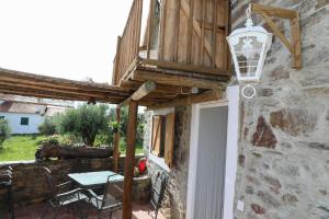 a patio with a table and a light on a building at Casa da Moleira in Chaveirinha