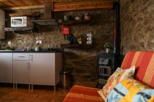 a kitchen with a counter and a stove at Casa da Moleira in Chaveirinha