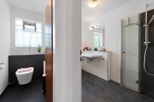 a bathroom with a toilet and a sink at Ferienwohnungen Kopp in Hagnau +92 photos