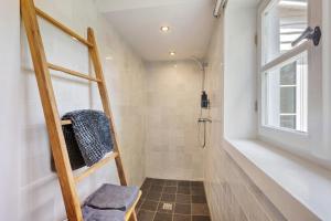 a bathroom with a walk in shower next to a window at Gästehaus Altes Forstamt Sinntal in Sinntal