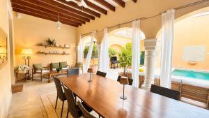 a dining room with a table and a pool at Villa Nekazabal in Sa Pobla +33 photos