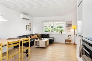 a living room with a couch and a table at SB134-Sydals-Osterbyvej-54-B in Østerby