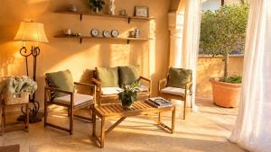 a living room with two chairs and a table at Villa Nekazabal in Sa Pobla