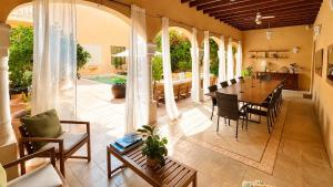 a large living room with a table and chairs at Villa Nekazabal in Sa Pobla
