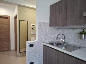 a kitchen with a sink and a counter top at Eira Apartment Potenza in Potenza