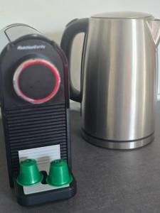 a small appliance on a counter next to a tea kettle at Le 2 valli in Moltrasio