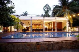 a swimming pool in front of a building at River Tree Bolgoda in Panadura