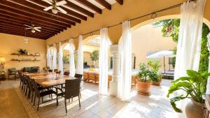 a dining room with a table and chairs at Villa Nekazabal in Sa Pobla