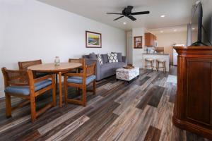 a living room with a table and a couch at Sea Gull Queen Suite in Cayucos