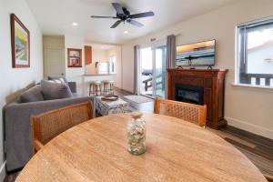 a living room with a table and a couch at Sea Gull Queen Suite in Cayucos