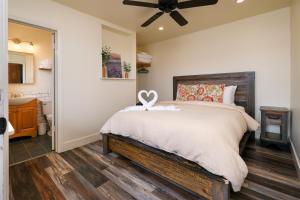 a bedroom with a bed and a ceiling fan at Sea Gull Queen Suite in Cayucos
