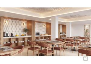 a restaurant with tables and chairs and a kitchen at Aduana Suites in Salou +25 photos