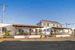 a large white house with a porch at Sea Gull Queen Suite in Cayucos