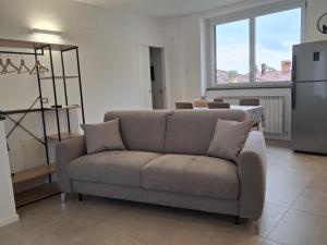 a living room with a couch and a large window at Il Borgo in Lurago D'Erba 