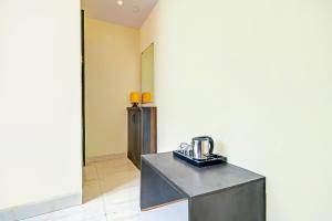 a room with a counter with a coffee maker on it at Hotel O Paradise Green in Indore +21 photos
