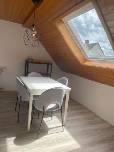 a white table and chairs in a room with a window at Apartment Kuhl in Selb