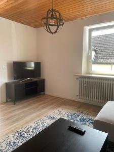 a living room with a couch and a tv at Apartment Kuhl in Selb