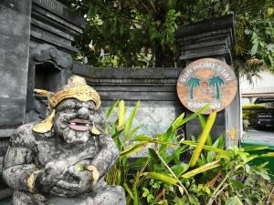 a statue of a monkey in front of a sign at Sun Homestay Canggu in Canggu