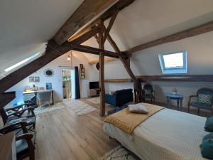 a bedroom with a bed and a living room at Le Clos Macé - Maison d'hôtes proche BLOIS CHAMBORD in Saint-Denis-sur-Loire
