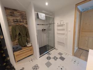 a bathroom with a shower and a tiled floor at Le Clos Macé - Maison d'hôtes proche BLOIS CHAMBORD in Saint-Denis-sur-Loire +82 photos