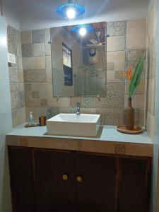 a bathroom with a sink and a mirror at Longchen Homestay in Dimapur