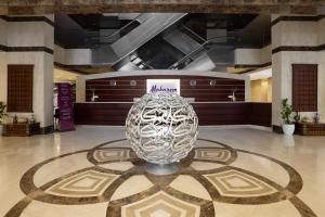 a large glass vase sitting on a floor in a lobby at Makarem Umm Al Qura Hotel in Mecca