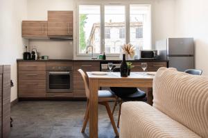 a kitchen with a wooden table with two wine glasses at Appart Cosy I Centre-ville in Istres