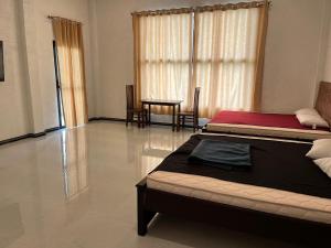 a bedroom with a bed and a table and chairs at N4 Rest Hanthana in Etulgama